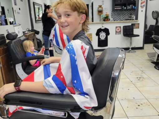 460606295_10126958570720054_4748791547871005555_n-1200x1200 Child getting a stylish haircut at JD Barber Shop for kids grooming services.