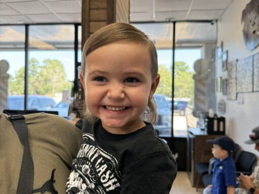 JD Barber Shop Magnolia TX Photo Gallery Smiling young boy at JD Barber Shop receiving haircut in a modern, family-friendly salon.