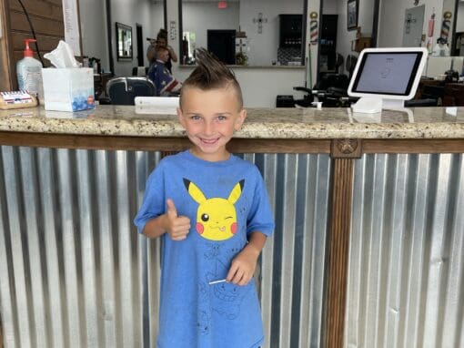 JD Barber Shop Magnolia TX Photo Gallery Child smiling at JD Barber Shop, kids haircut and grooming services offered.