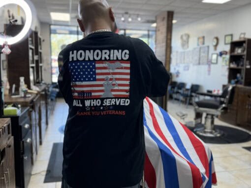 JD Barber Shop Magnolia TX Photo Gallery Veteran tribute haircut at JD Barber Shop with honoring T-shirt and patriotic decor.