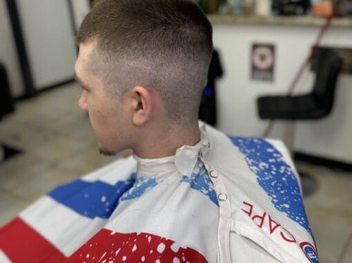 JD Barber Shop Traditional Barber Shop Services in Magnolia, Texas Close-up of a modern men's haircut at JD Barber Shop, with fade style and textured top.